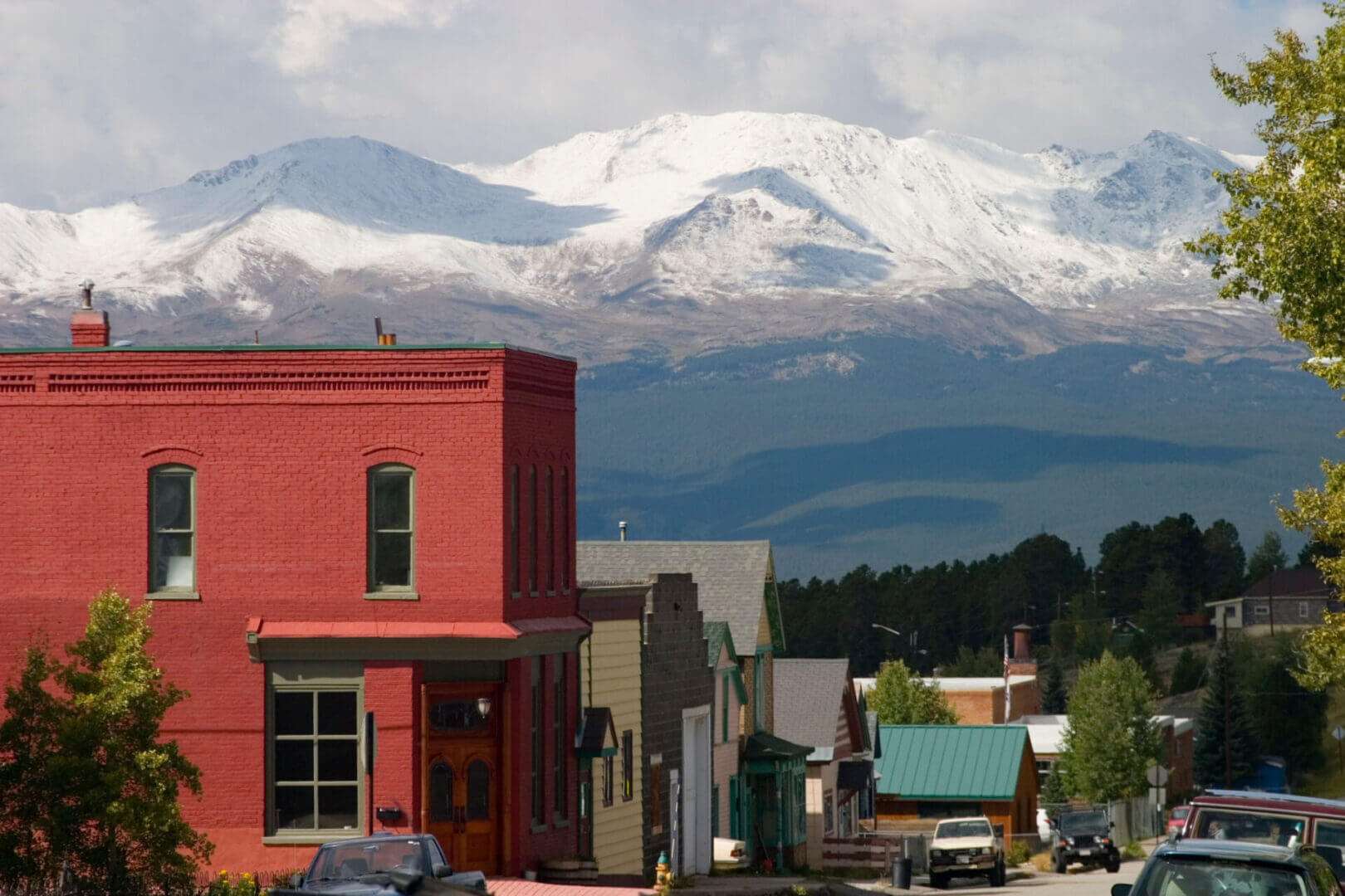 Mountain town with colorful buildings and snow.